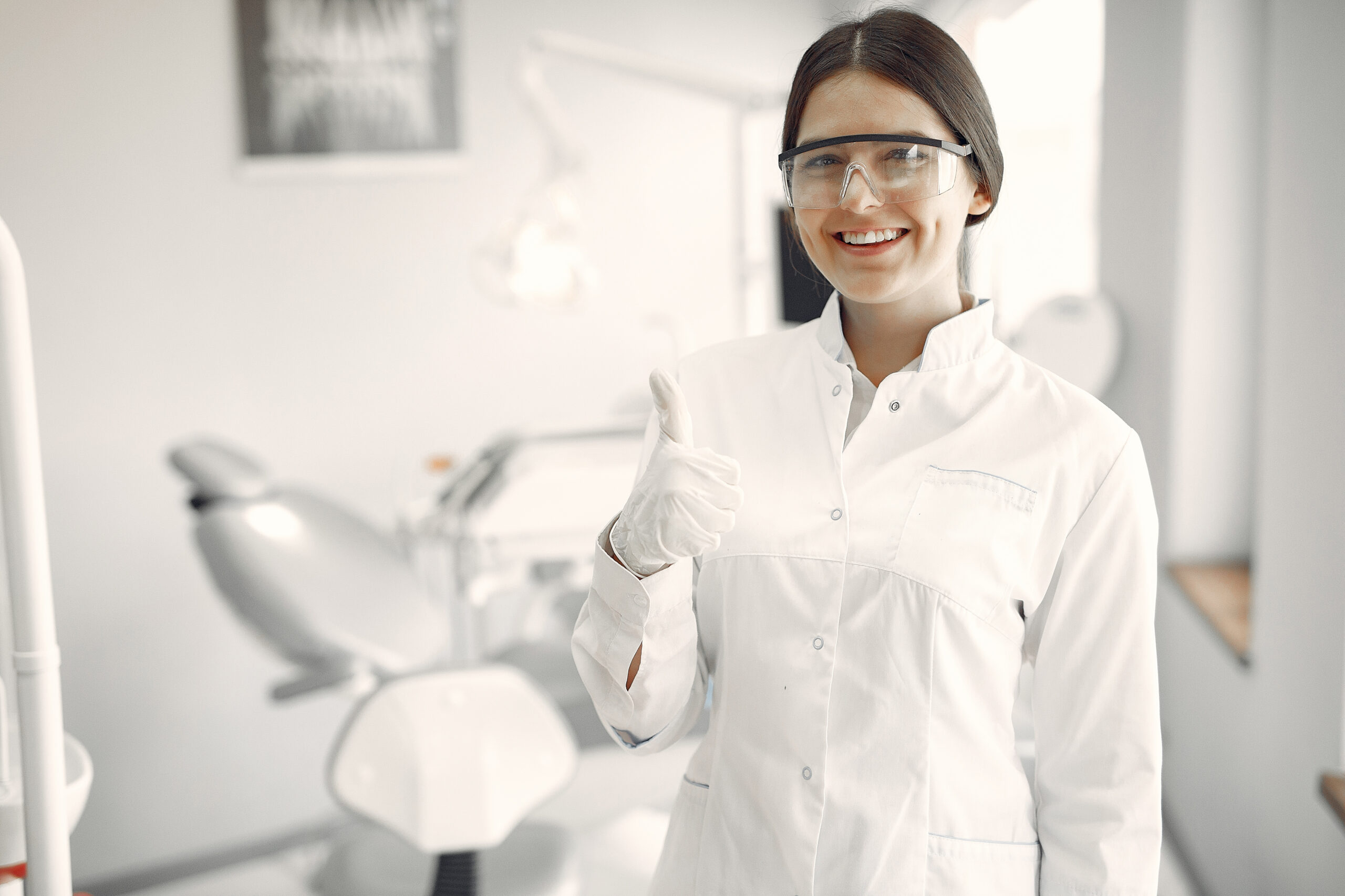 Beautiful dentist working on a dental clinic Male doctor showing x-ray pictures of teeth on tablet