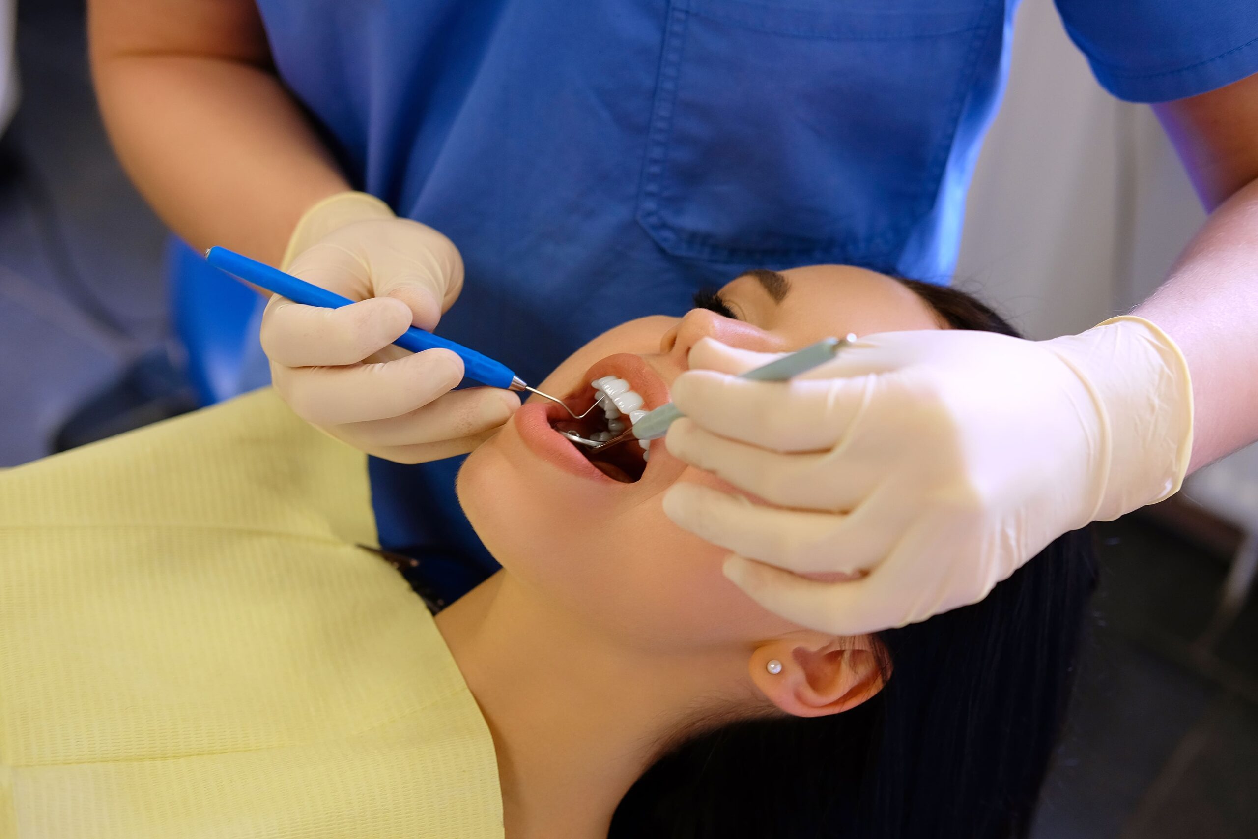 4 Female patient receiving a dental checkup