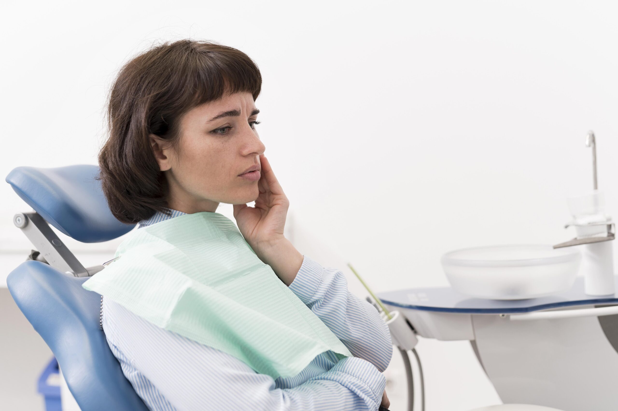 female-patient-having-toothache-dentist-s-office Female patient receiving a dental checkup